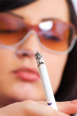 picture young girl smoking cigarette - Young girl smoking - focus on the cigarette Stock Photo - Budget Royalty-Free & Subscription, Code: 400-04365747