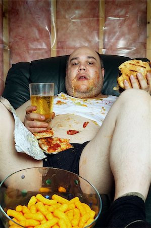 Photo of a fat couch potato eating a huge hamburger and watching television.  Harsh lighting from the television illuminates the dark room. Stock Photo - Budget Royalty-Free & Subscription, Code: 400-04363164