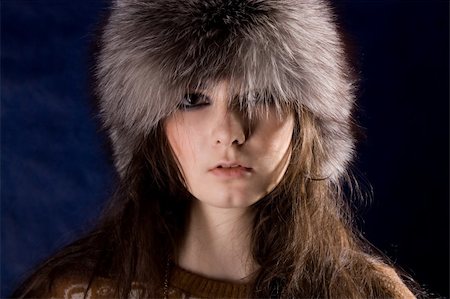 The beautiful mystical women  in fur-cap on the dark blue background. Stock Photo - Budget Royalty-Free & Subscription, Code: 400-04363227