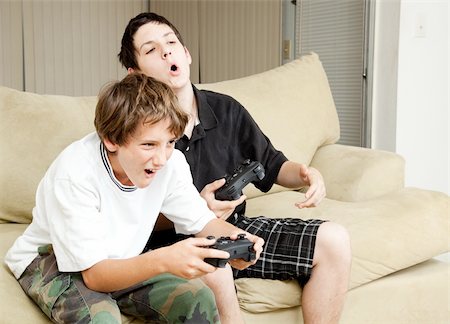 simsearch:400-05751526,k - Two boys playing video games with intense competition. Stock Photo - Budget Royalty-Free & Subscription, Code: 400-04374241