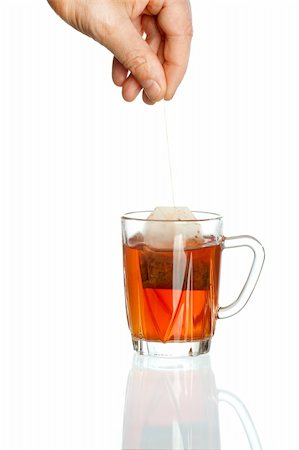 simsearch:400-04273561,k - Transparent teacup and hand holding tea bag Stock Photo - Budget Royalty-Free & Subscription, Code: 400-04376163