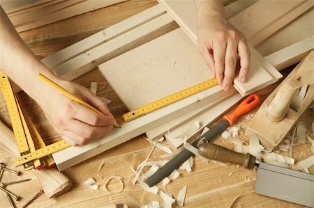 Wooden workshop table with tools. Man's arms measuring. Stock Photo - Budget Royalty-Free & Subscription, Code: 400-04378183