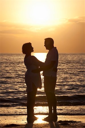 Senior man and woman couple embracing together at sunset on a beautiful tropical beach Stock Photo - Budget Royalty-Free & Subscription, Code: 400-04371481