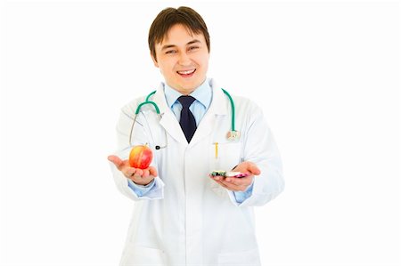simsearch:6109-06006928,k - Smiling medical doctor with pills in one hand and apple in other isolated on white Stock Photo - Budget Royalty-Free & Subscription, Code: 400-04371563