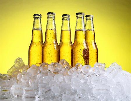 simsearch:400-04083275,k - Bottles of cold and fresh beer with ice over yellow background Stock Photo - Budget Royalty-Free & Subscription, Code: 400-04384964