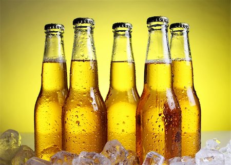 simsearch:400-04083275,k - Bottles of cold and fresh beer with ice over yellow background Stock Photo - Budget Royalty-Free & Subscription, Code: 400-04384965
