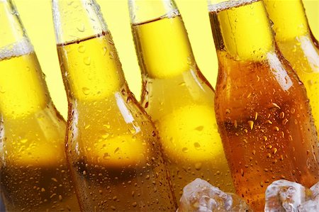 simsearch:400-04083275,k - Bottles of cold and fresh beer with ice over yellow background Stock Photo - Budget Royalty-Free & Subscription, Code: 400-04384967