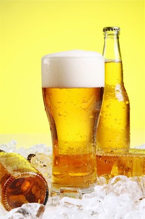 simsearch:400-04083275,k - Bottles and Glass of beer with foam over yellow background Stock Photo - Budget Royalty-Free & Subscription, Code: 400-04384975