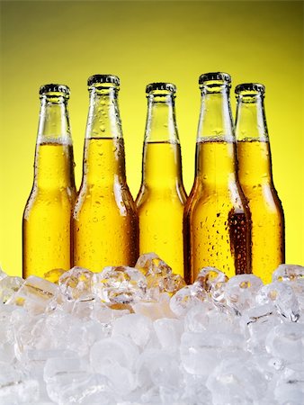 simsearch:400-04083275,k - Bottles and Glass of beer with foam over yellow background Stock Photo - Budget Royalty-Free & Subscription, Code: 400-04384970