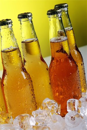 simsearch:400-04083275,k - Bottles of cold and fresh beer with ice over yellow background Stock Photo - Budget Royalty-Free & Subscription, Code: 400-04384971