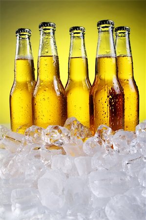 simsearch:400-04083275,k - Bottles of cold and fresh beer with ice over yellow background Stock Photo - Budget Royalty-Free & Subscription, Code: 400-04384972