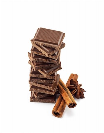 Chocolate bars stack and cinnamon sticks isolated on white background Foto de stock - Super Valor sin royalties y Suscripción, Código: 400-04385109