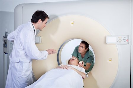 Doctor instructing technician while preparing patient for MRI scan Stock Photo - Budget Royalty-Free & Subscription, Code: 400-04386092