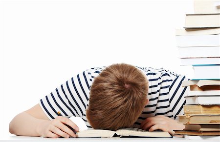 Tired student at the desk, isolated on white Stock Photo - Budget Royalty-Free & Subscription, Code: 400-04389887