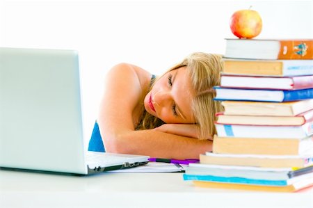 Tired young girl sleeping on table with books and laptop Stock Photo - Budget Royalty-Free & Subscription, Code: 400-04380528