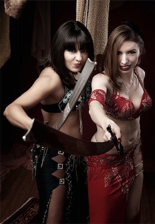 simsearch:400-04435419,k - Two beautiful belly dancers hold traditional swords Stock Photo - Budget Royalty-Free & Subscription, Code: 400-04380546
