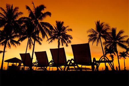 simsearch:400-07748817,k - Row deckchairs on beach at sunset, Tanjung Aru, Malaysia. Stock Photo - Budget Royalty-Free & Subscription, Code: 400-04382280