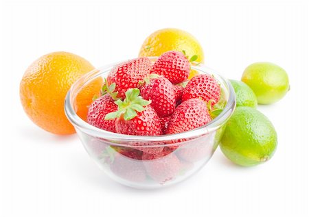 simsearch:400-05370991,k - Glass bowl filled with fresh ripe strawberries arranged with some citrus fruits  oranges and limes around  isolated on white background Stock Photo - Budget Royalty-Free & Subscription, Code: 400-04383033