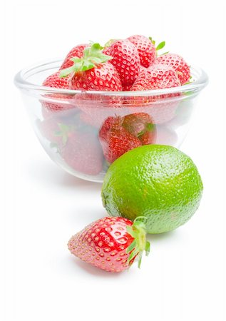 simsearch:400-05370991,k - Glass bowl filled with strawberries arranged with single whole lime and strawberry fruit isolated on white background Stock Photo - Budget Royalty-Free & Subscription, Code: 400-04383200
