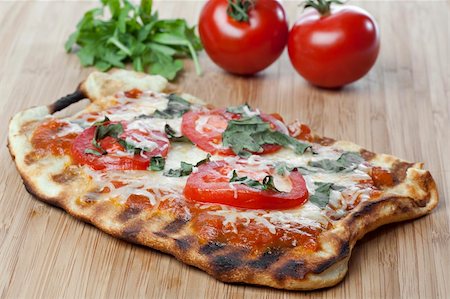 Homemade margarita pizza with tomatoes, cheese, and basil Stock Photo - Budget Royalty-Free & Subscription, Code: 400-04396265