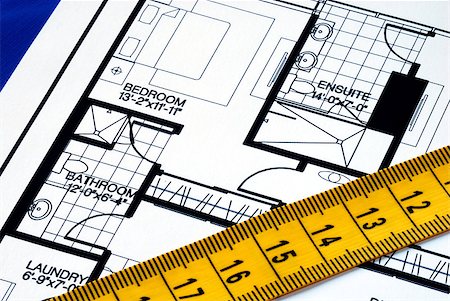 Measure the floorplan with a  measuring tape isolated on blue Stock Photo - Budget Royalty-Free & Subscription, Code: 400-04397993