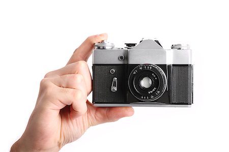 simsearch:400-04590657,k - A picture of a male hand holding a camera over white background Stock Photo - Budget Royalty-Free & Subscription, Code: 400-04398514