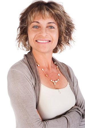 Attractive senior woman with folded arms isolated over white background. Photographie de stock - Aubaine LD & Abonnement, Code: 400-04398970