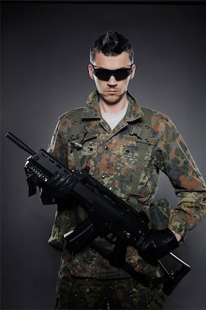 simsearch:400-04072400,k - Young soldier in camouflage and ammunition with a rifle. studio shot Stock Photo - Budget Royalty-Free & Subscription, Code: 400-04390872