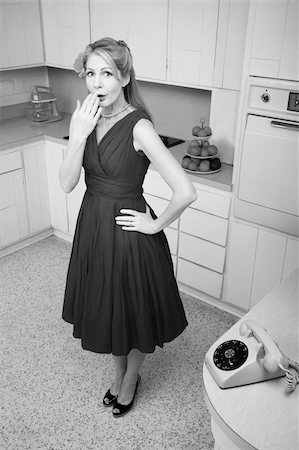 simsearch:400-04831298,k - Forgetful middle-aged Caucasian woman with hand on hip in retro-styled kitchen scene Stock Photo - Budget Royalty-Free & Subscription, Code: 400-04391478