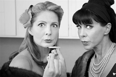 Two retro-styled Caucasian women in mink coats smoke weed Stock Photo - Budget Royalty-Free & Subscription, Code: 400-04391488