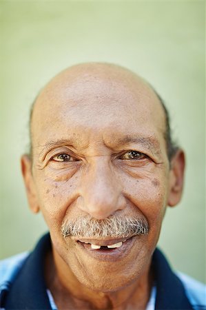 simsearch:400-06142278,k - portrait of senior hispanic man with dental problems looking at camera against green wall. Vertical shape Stock Photo - Budget Royalty-Free & Subscription, Code: 400-04404908