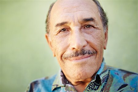 simsearch:400-06142278,k - portrait of senior hispanic man with mustache looking at camera against green wall and smiling. Horizontal shape, copy space Stock Photo - Budget Royalty-Free & Subscription, Code: 400-04404911