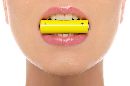 Woman holding battery in her mouth isolated on white Stock Photo - Budget Royalty-Free & Subscription, Code: 400-04405017