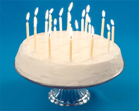 Birthday cake with burning candles on blue background Stock Photo - Budget Royalty-Free & Subscription, Code: 400-04406252