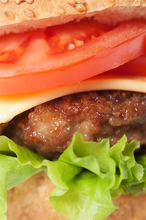 simsearch:400-06090558,k - Cheeseburger with tomatoes and lettuce, macro Stock Photo - Budget Royalty-Free & Subscription, Code: 400-04406566