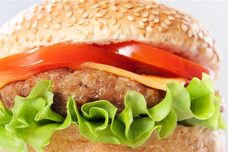 simsearch:400-06090558,k - Cheeseburger with tomatoes and lettuce, macro Stock Photo - Budget Royalty-Free & Subscription, Code: 400-04406568