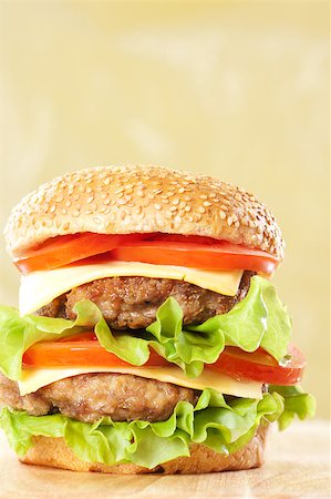 simsearch:400-06090558,k - Double cheeseburger with tomatoes and lettuce on yellow background Stock Photo - Budget Royalty-Free & Subscription, Code: 400-04406654