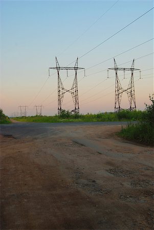 Landscape with high-voltage line over the road. Perspective in warm morning light Stock Photo - Budget Royalty-Free & Subscription, Code: 400-04406841