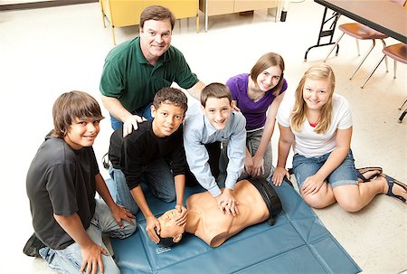 simsearch:400-07411030,k - A group of teenage students learning CPR life saving techniques in class. Stock Photo - Budget Royalty-Free & Subscription, Code: 400-04406952