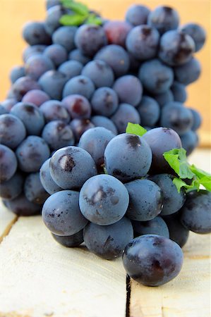 simsearch:846-03166143,k - Brush black sweet grapes in a basket on wooden table Stock Photo - Budget Royalty-Free & Subscription, Code: 400-04407368