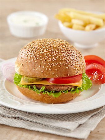 simsearch:400-06090558,k - fresh cheeseburger with vegetables on white plate Stock Photo - Budget Royalty-Free & Subscription, Code: 400-04409604