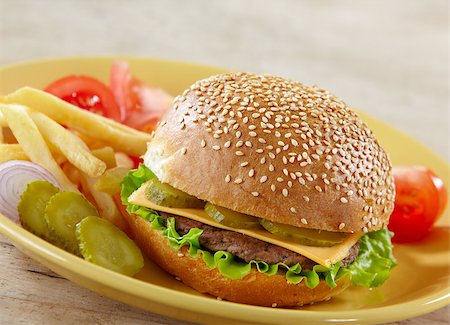 simsearch:400-06090558,k - fresh cheeseburger with vegetables on yellow plate Stock Photo - Budget Royalty-Free & Subscription, Code: 400-04409603
