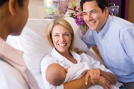 New parents with baby talking to doctor and smiling Stock Photo - Budget Royalty-Free & Subscription, Code: 400-04400716