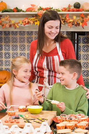 Mother and two children at Halloween making treats and smiling Stock Photo - Budget Royalty-Free & Subscription, Code: 400-04402179