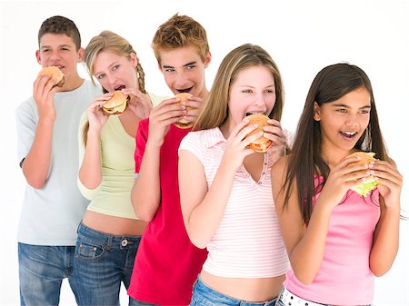 simsearch:400-04199223,k - Row of five friends eating hamburgers Stock Photo - Budget Royalty-Free & Subscription, Code: 400-04402297