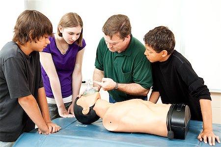 simsearch:400-07411030,k - Teacher demonstrates to students how to use an oxygen mask for CPR. Stock Photo - Budget Royalty-Free & Subscription, Code: 400-04414090
