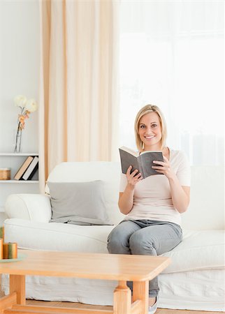 simsearch:400-04418460,k - Portrait of a blond-haired woman with a book in her living room Stock Photo - Budget Royalty-Free & Subscription, Code: 400-04418461