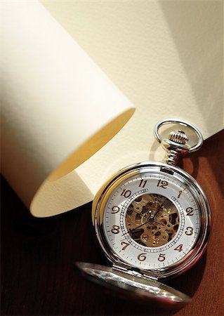 pocket watch - Closeup of nice pocket watch with open lid lying on blank scroll Stock Photo - Budget Royalty-Free & Subscription, Code: 400-04419451