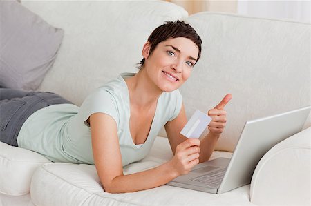 simsearch:400-04410667,k - Happy woman shopping online with her thumb but Stock Photo - Budget Royalty-Free & Subscription, Code: 400-04410664