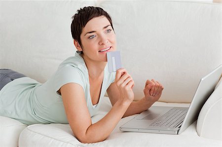 simsearch:400-04410667,k - Pensive woman buying online in her living room Stock Photo - Budget Royalty-Free & Subscription, Code: 400-04410665